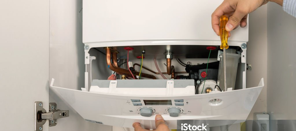 Technician repairing combi Gas Boiler